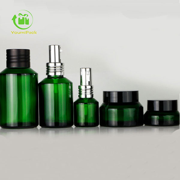 Green glass bottles and jars set for skincare